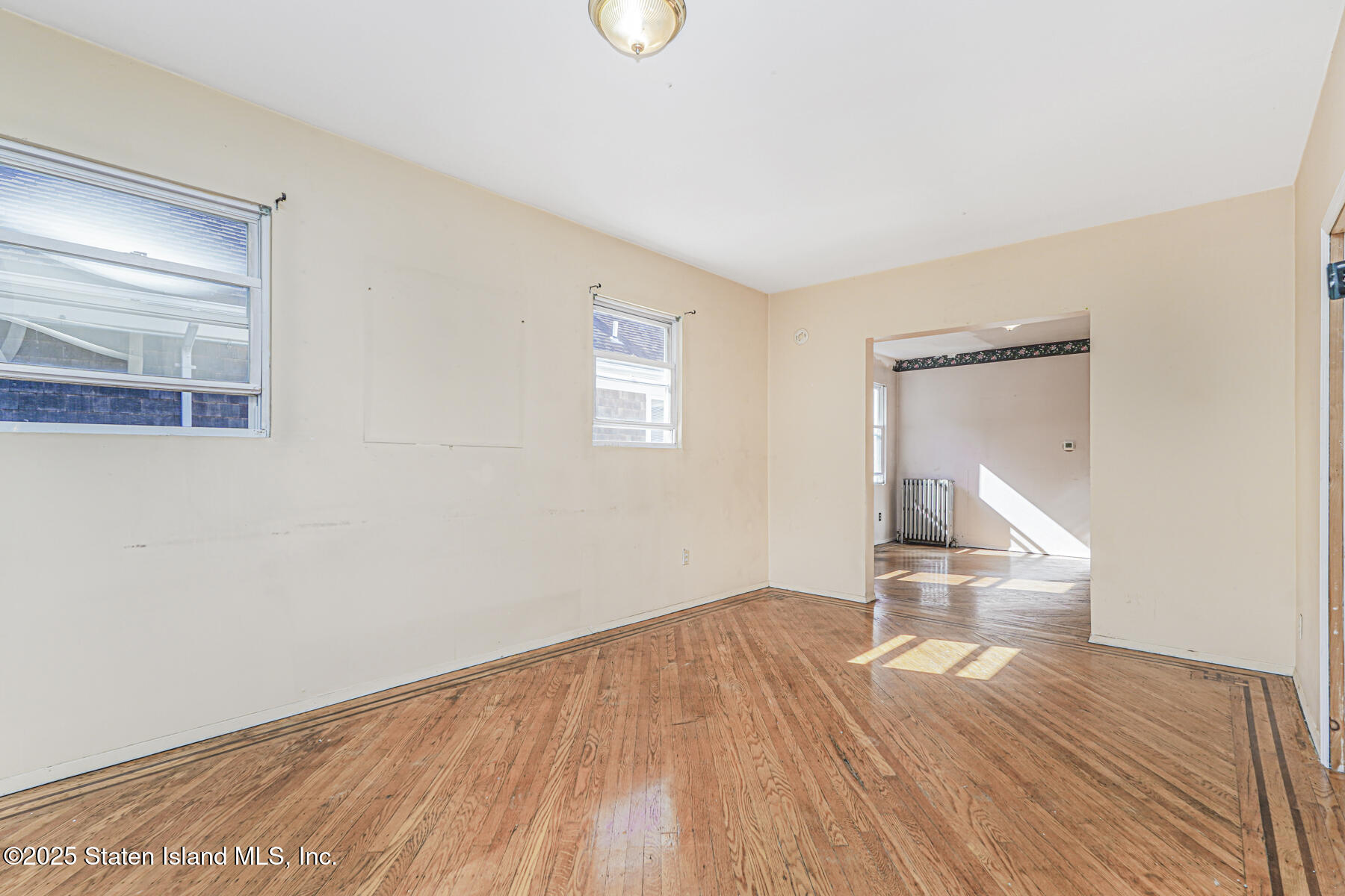 252 Dickie Avenue Staten Island, NY 10314 - Photo 8 of 37 a view of empty room with wooden floor and fan