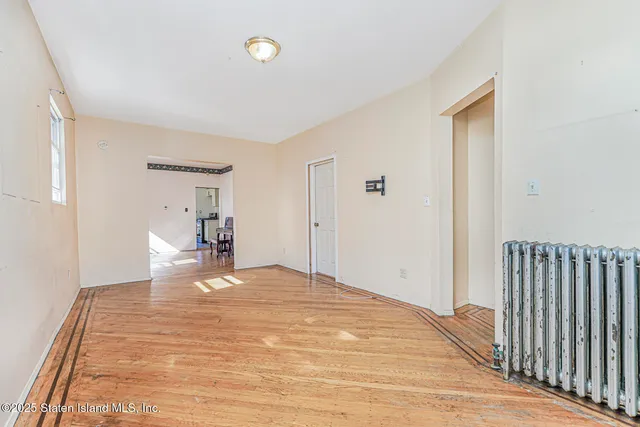 a view of a bedroom with wooden floor