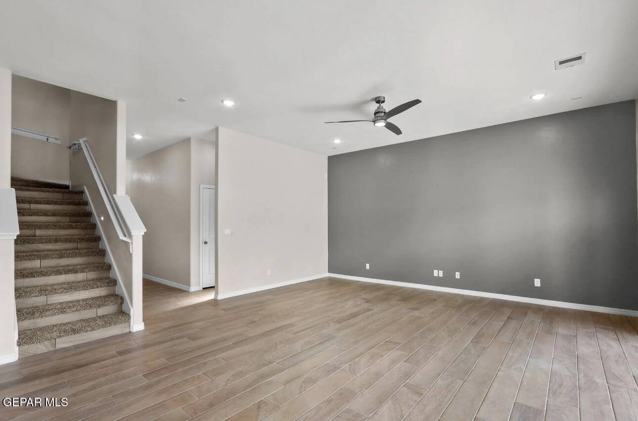15245 Conviction Street El Paso, TX 79938 - Photo 8 of 16 a view of room with stairs and wooden floor