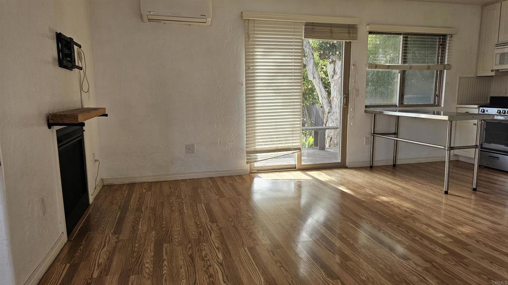 735 Avocado Court, Unit GUEST HOUS Del Mar, CA 92014 - Photo 3 of 12 a view of a room with wooden floor and a window