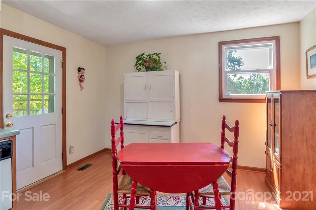 1158 Trammel Gap Road Saluda, NC 28773 - Photo 14 of 32 a dining room with furniture and window