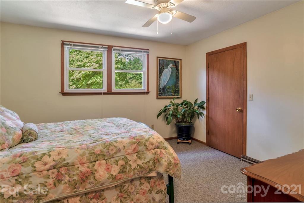 1158 Trammel Gap Road Saluda, NC 28773 - Photo 17 of 32 a bedroom with a bed and a window