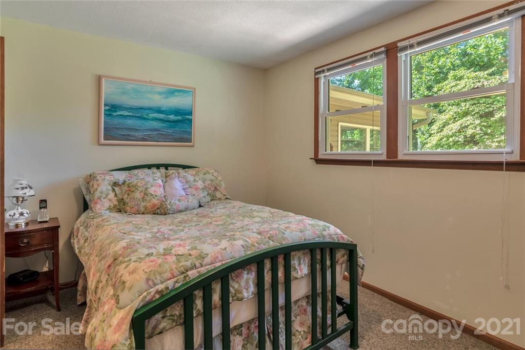 1158 Trammel Gap Road Saluda, NC 28773 - Photo 18 of 32 a bedroom with a bed and a window