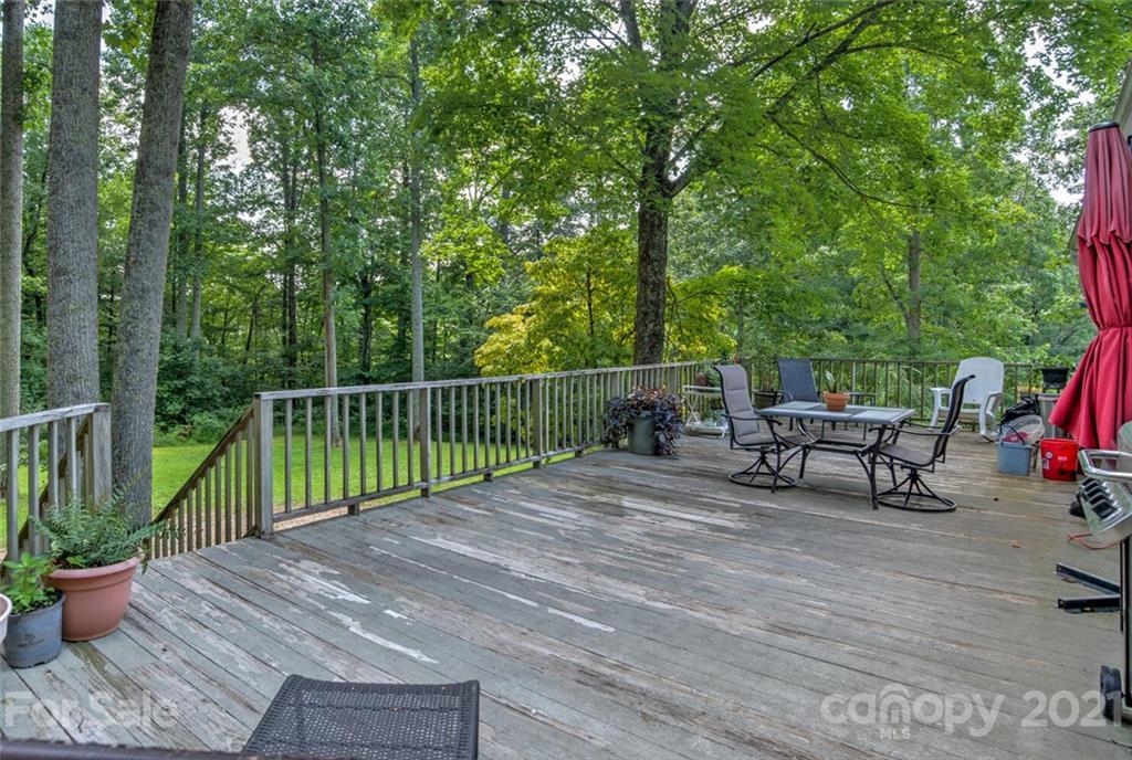 1158 Trammel Gap Road Saluda, NC 28773 - Photo 23 of 32 a view of a chairs and table on the wooden deck