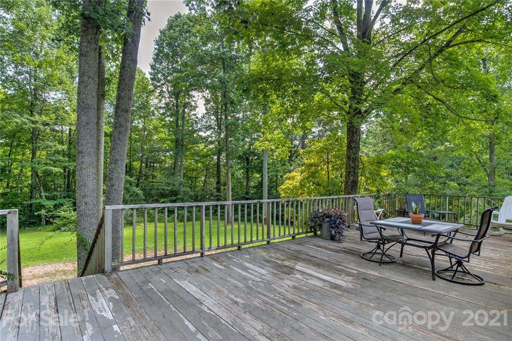 1158 Trammel Gap Road Saluda, NC 28773 - Photo 24 of 32 a view of a bench in a backyard
