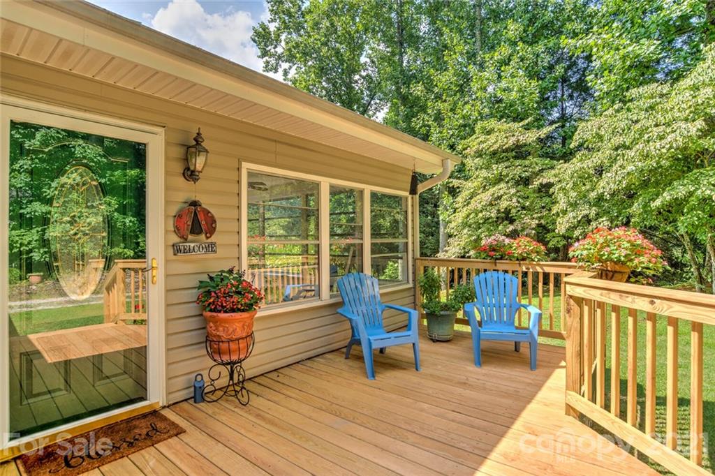 1158 Trammel Gap Road Saluda, NC 28773 - Photo 4 of 32 a balcony with furniture and wooden floor