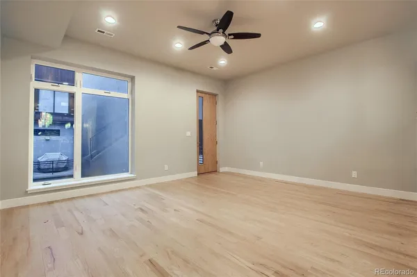 a view of an empty room with a ceiling fan