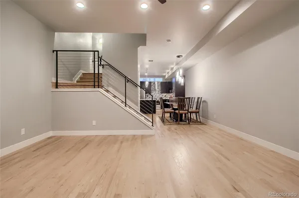 a view of entryway and hall with wooden floor