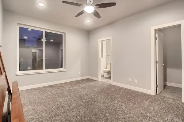 an empty room with fan and entrance