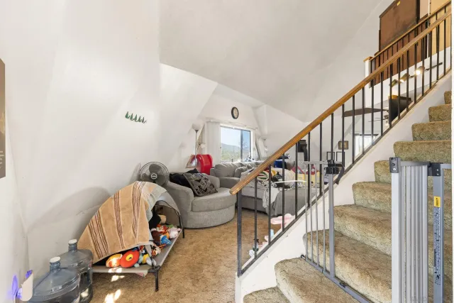 a bedroom with furniture and a flat screen tv