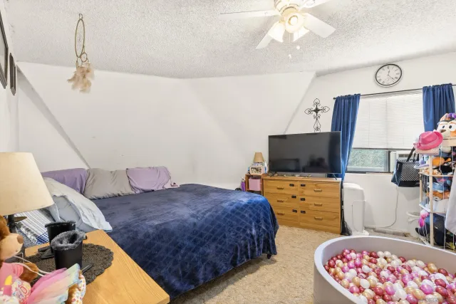 a bed room with a bed and a chair