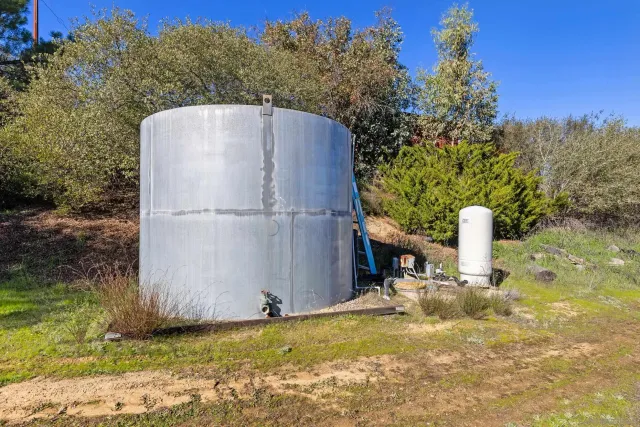 an aerial view of residential houses with city and mountain view in back