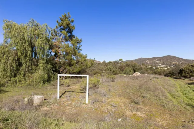 an aerial view of a house with a yard and garden