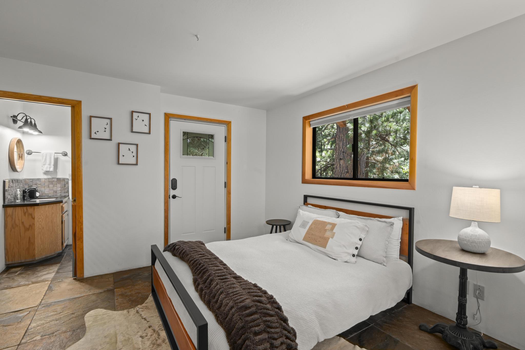 24747 Fern Valley Road Idyllwild, CA 92549 - Photo 34 of 42 a bedroom with a bed and painting on the wall