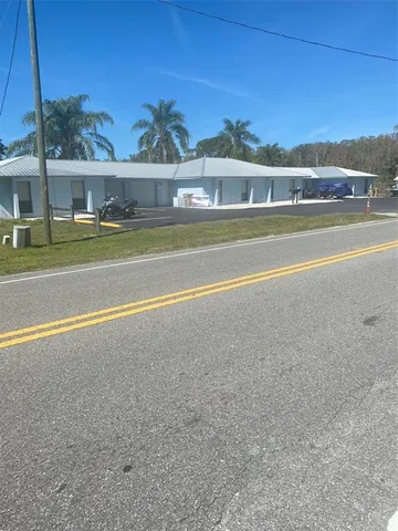 a view of large trees and a big yard