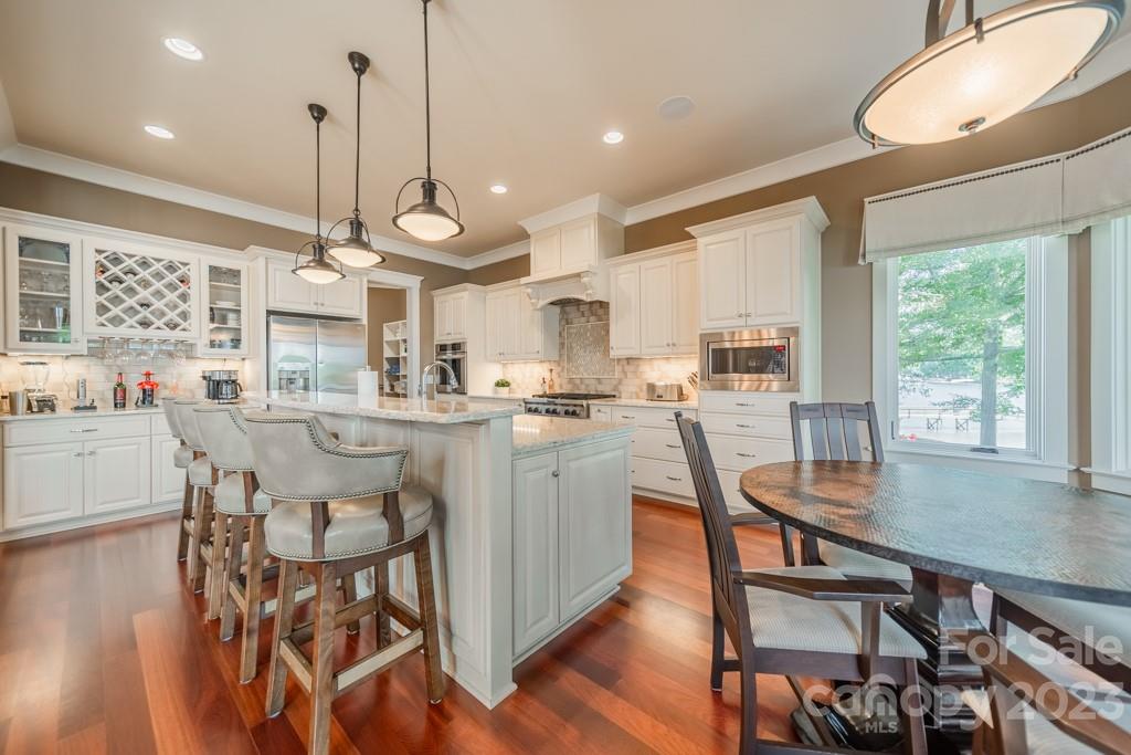 218 Queens Cove Road Mooresville, NC 28117 - Photo 12 of 42 a large kitchen with a table and chairs