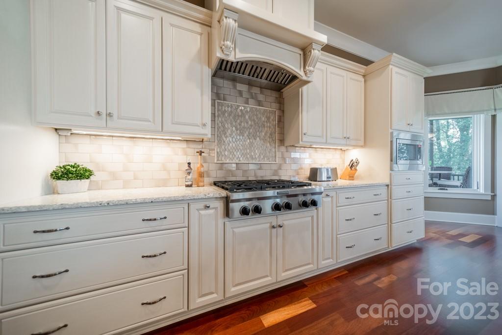 218 Queens Cove Road Mooresville, NC 28117 - Photo 13 of 42 a kitchen with granite countertop white cabinets and white appliances