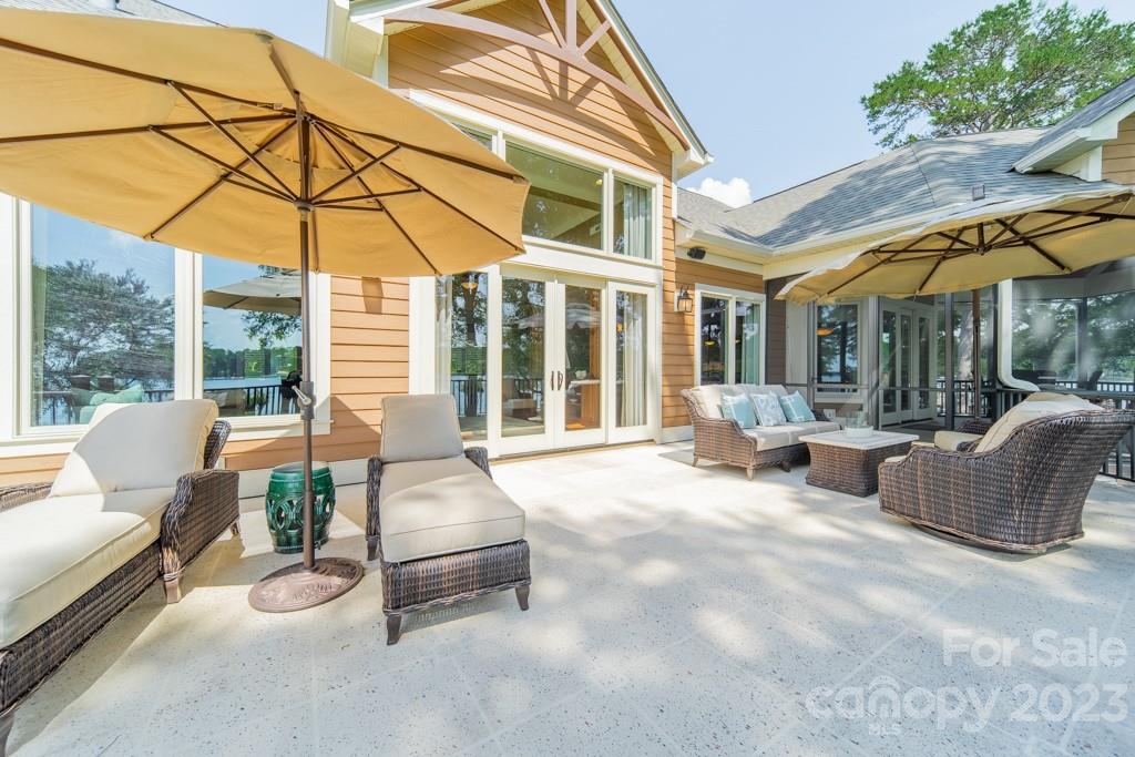 218 Queens Cove Road Mooresville, NC 28117 - Photo 19 of 42 a view of a patio with couches chairs and a small yard