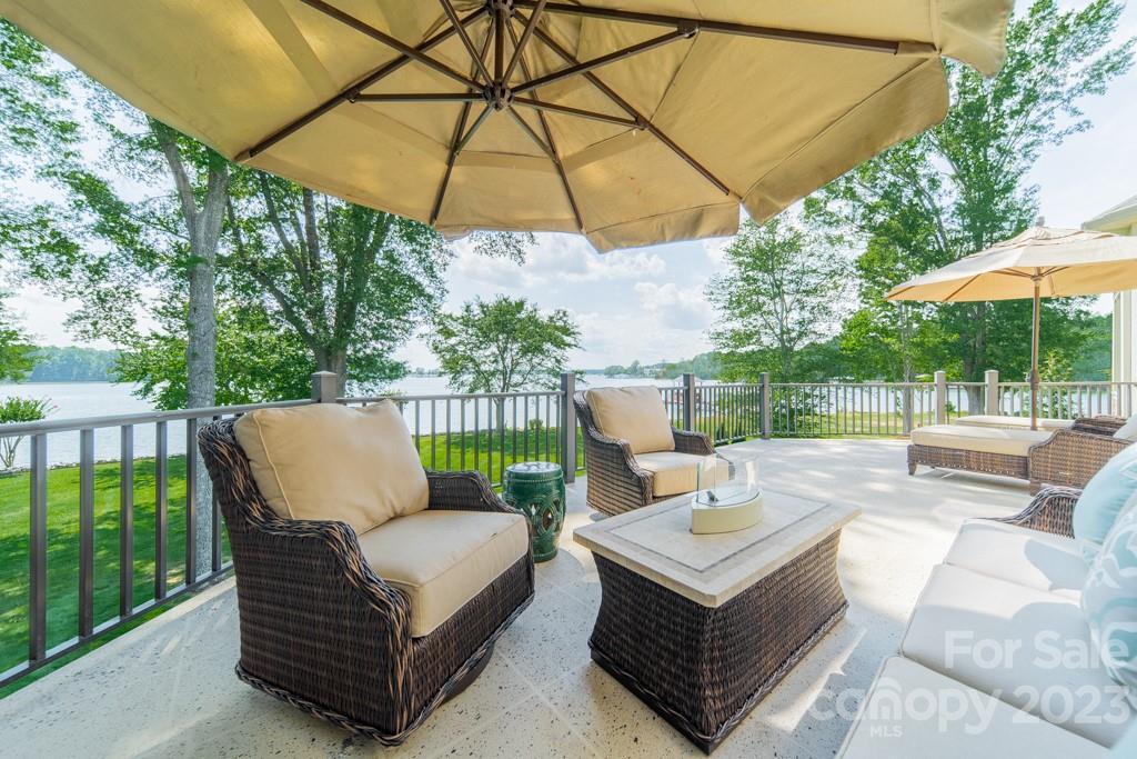 218 Queens Cove Road Mooresville, NC 28117 - Photo 20 of 42 a view of a patio with a table and chairs under an umbrella