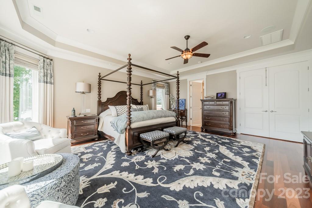 218 Queens Cove Road Mooresville, NC 28117 - Photo 22 of 42 a bedroom with a bed and a chandelier