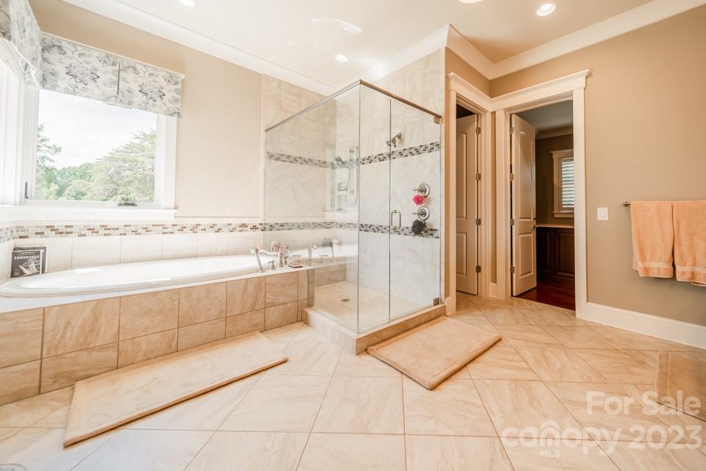 218 Queens Cove Road Mooresville, NC 28117 - Photo 24 of 42 a spacious bathroom with a tub sink and mirror