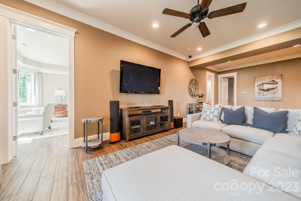 218 Queens Cove Road Mooresville, NC 28117 - Photo 29 of 42 a living room with furniture and a flat screen tv