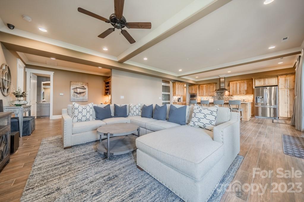218 Queens Cove Road Mooresville, NC 28117 - Photo 30 of 42 a living room with lots of white furniture and a rug