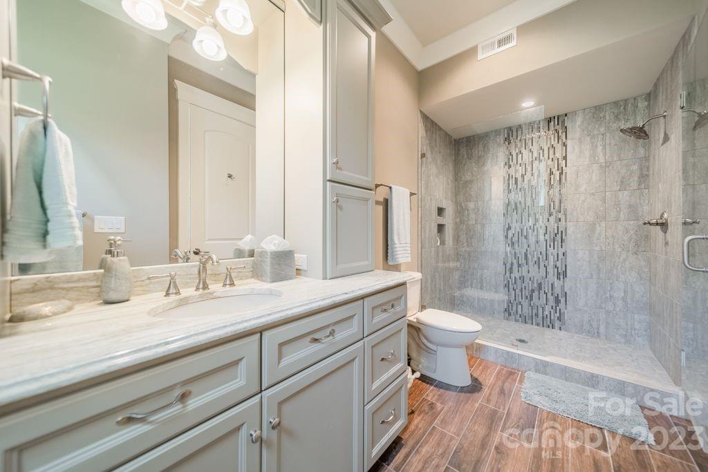 218 Queens Cove Road Mooresville, NC 28117 - Photo 35 of 42 a bathroom with a double vanity sink toilet and shower