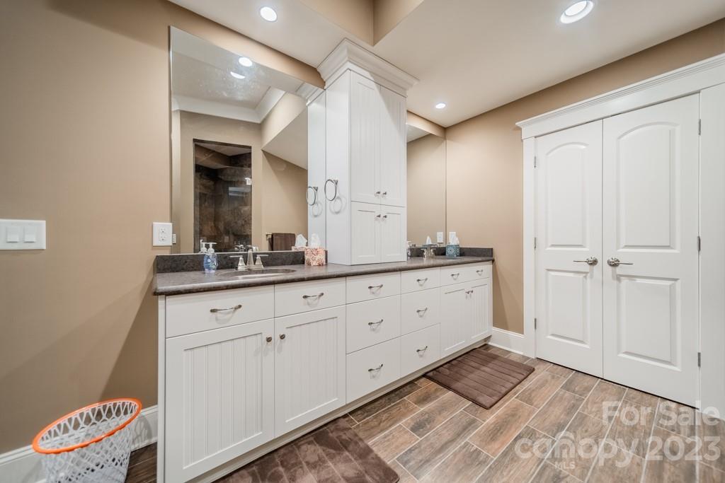 218 Queens Cove Road Mooresville, NC 28117 - Photo 38 of 42 a spacious bathroom with a granite countertop sink and a mirror