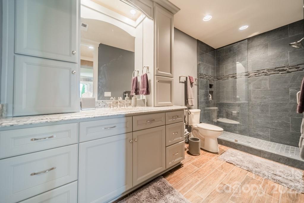 218 Queens Cove Road Mooresville, NC 28117 - Photo 40 of 42 a spacious bathroom with a double vanity sink toilet mirror and shower