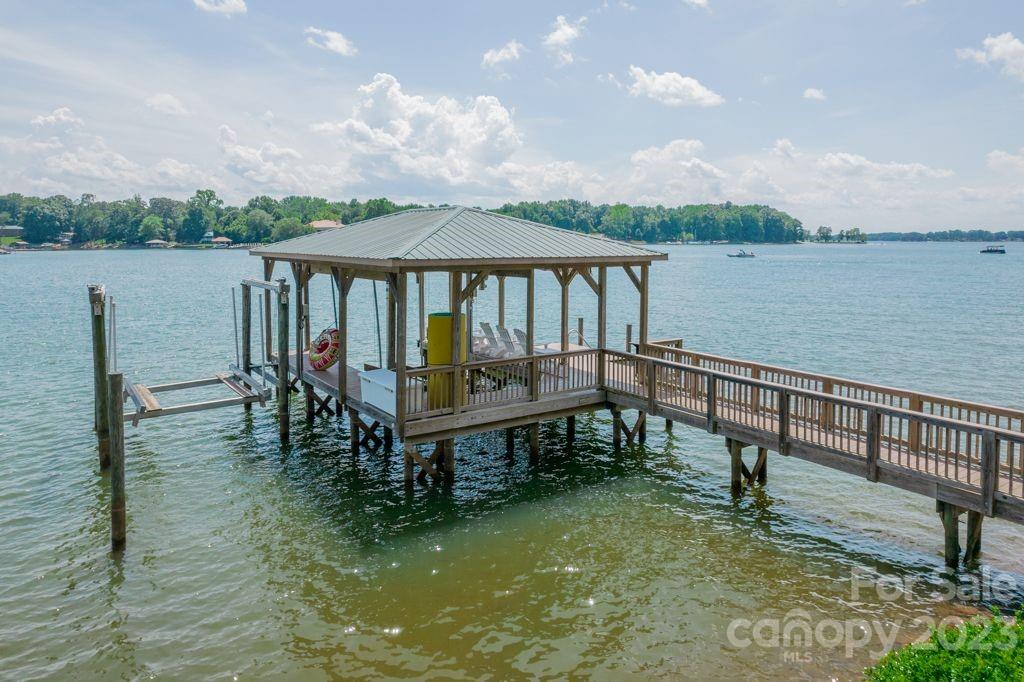 218 Queens Cove Road Mooresville, NC 28117 - Photo 7 of 42 a view of a lake with a table and chairs