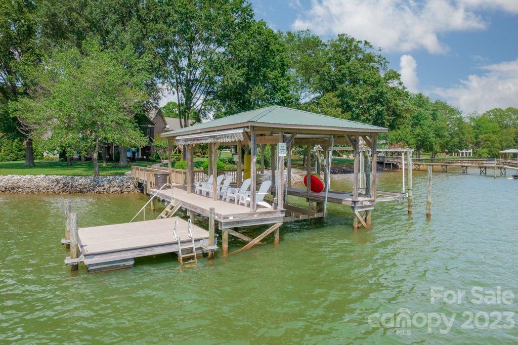 218 Queens Cove Road Mooresville, NC 28117 - Photo 9 of 42 an outdoor space with lounge chairs in the lake