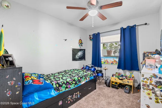 a bedroom with furniture a couch and a baby crib