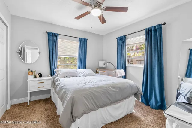 a bedroom with a bed dresser and a window