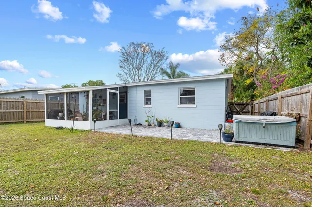 a backyard of a house with table and chairs