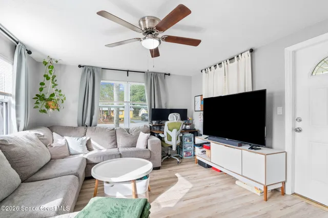 a living room with furniture and a flat screen tv