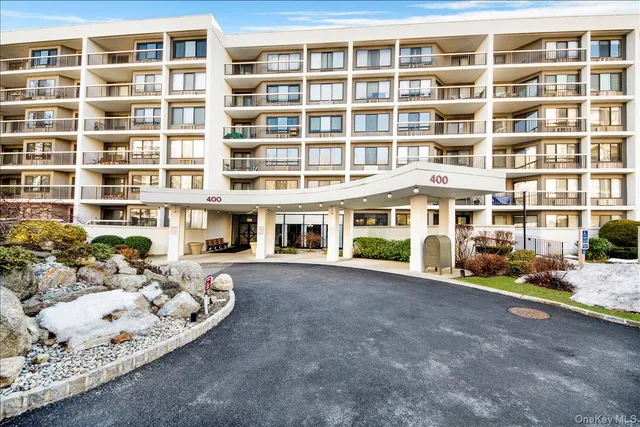 a front view of a building with a lot of windows
