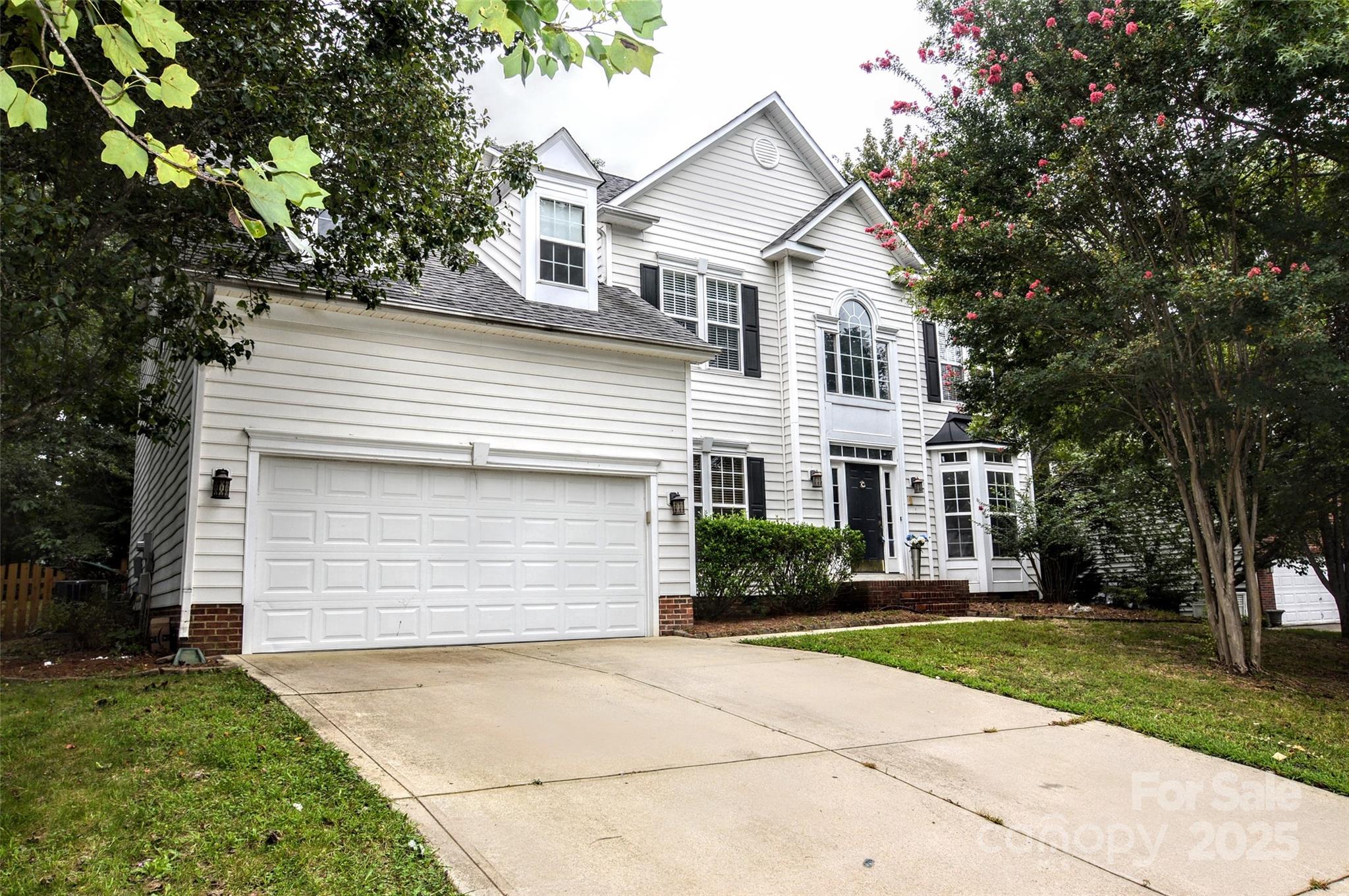 2035 Hollyhedge Lane Indian Trail, NC 28079 - Photo 1 of 32 a front view of a house with a yard and garage