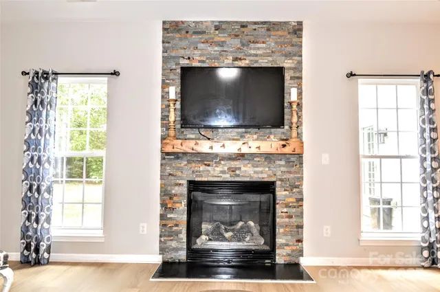 a living room with a fireplace and a flat screen tv