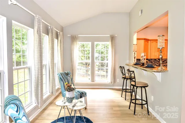 a living room with furniture and floor to ceiling windows