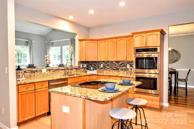 a kitchen with stainless steel appliances granite countertop a sink and cabinets