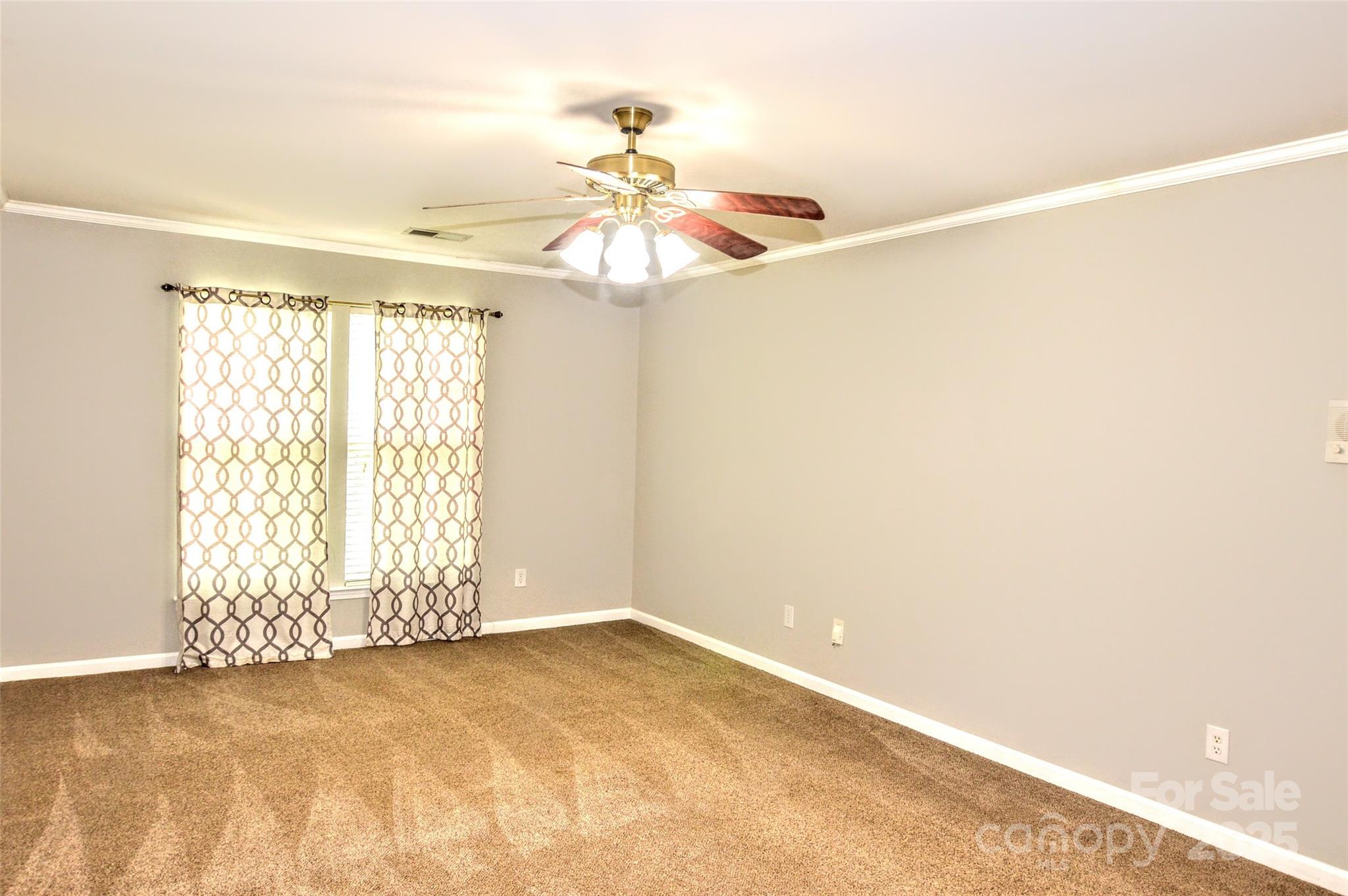 2035 Hollyhedge Lane Indian Trail, NC 28079 - Photo 17 of 32 an empty room with windows and fan