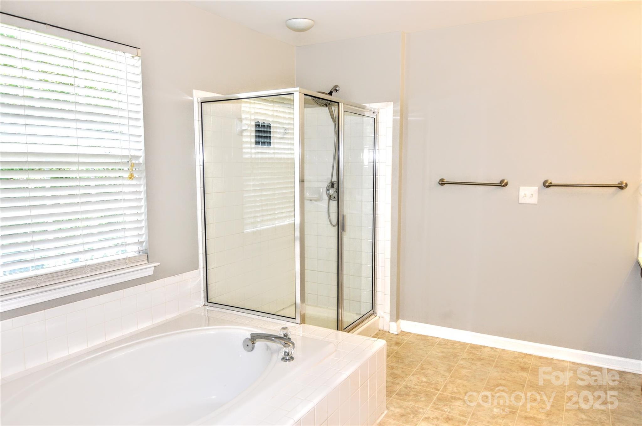2035 Hollyhedge Lane Indian Trail, NC 28079 - Photo 19 of 32 a bathroom with a bathtub and a shower