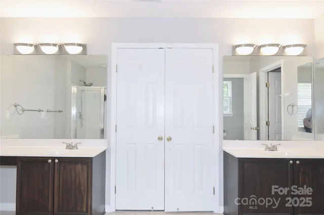 a bathroom with a double vanity sink and a mirror