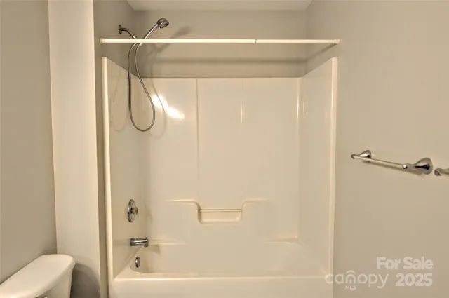 a bathroom with a shower and a sink