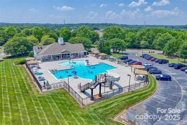 an aerial view of a house with swimming pool patio and outdoor seating