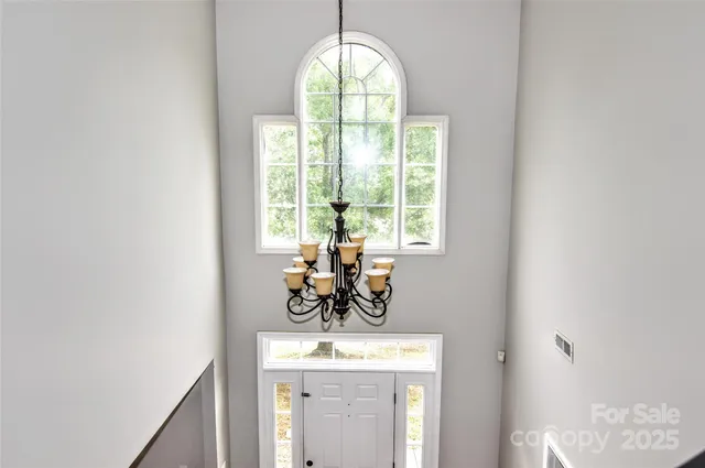 a view of a room with window and front door