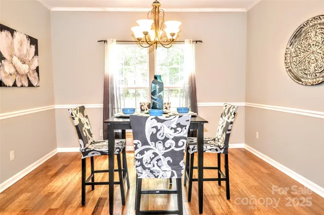 a view of a dining room with furniture and a window