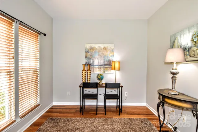 a workspace room with furniture and a window