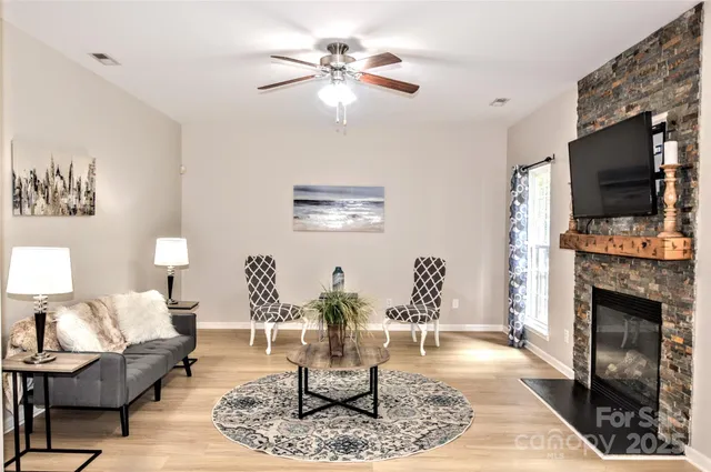 a living room with furniture a fireplace and a flat screen tv